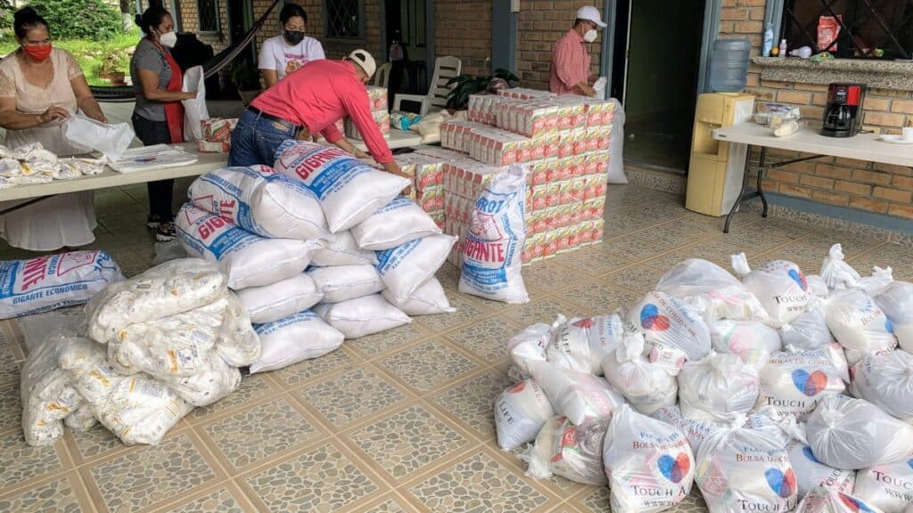Honduran villagers organize and distribute the contents of the "Bags of Hope" food supplies provided by the Final Frontiers Foundation.