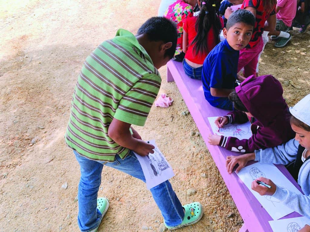 Children using the supplies they have to color.