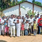 Pastor Suresh and his congregation on the plot of land they purchased to build a church