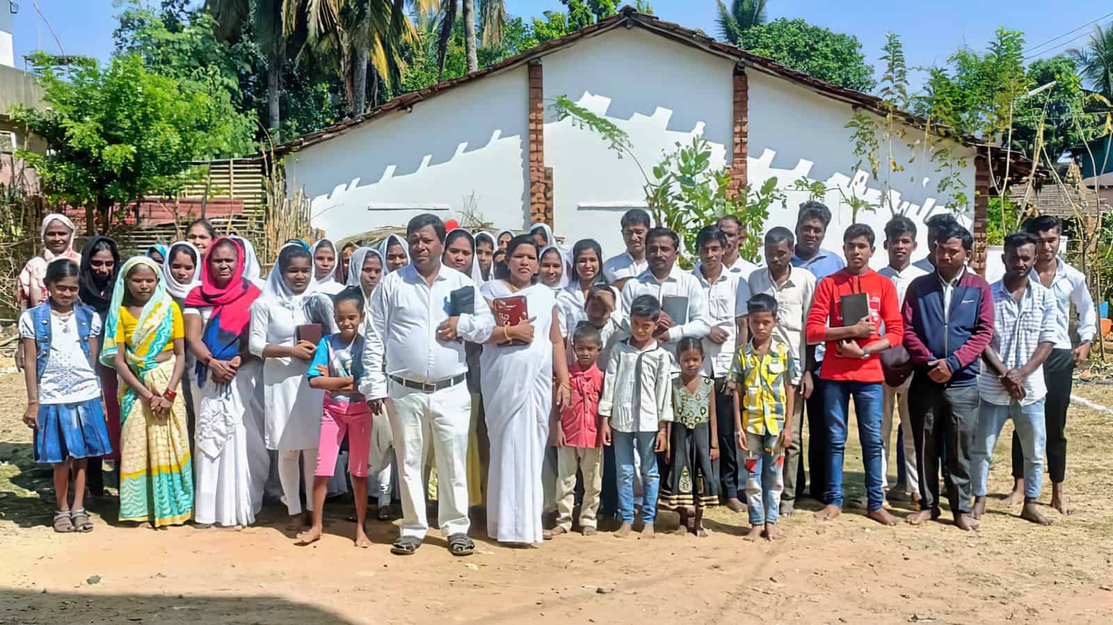 Pastor Suresh and his congregation on the plot of land they purchased to build a church