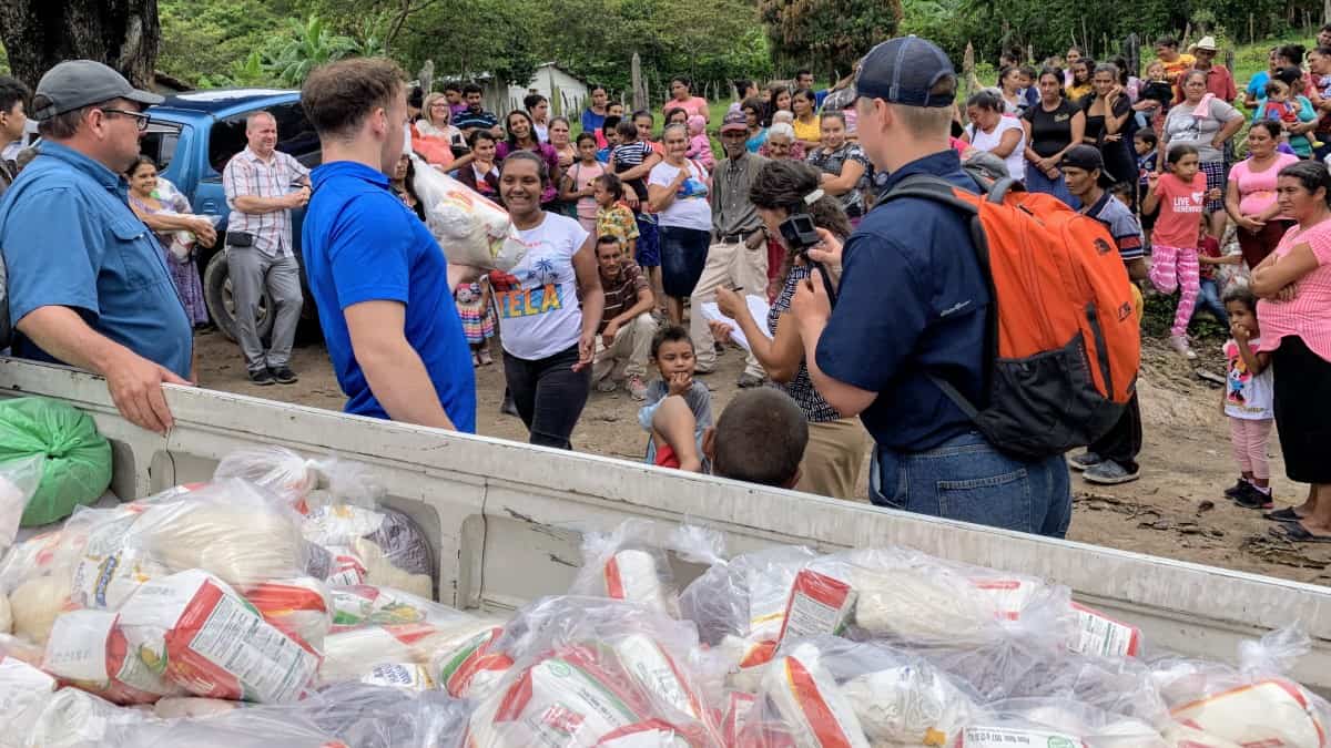 A group of Honduran villagers gather around a truckload of "Bags of Hope" food supplies provided by the Final Frontiers Foundation.