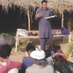 A man is giving a sermon to a group of people.